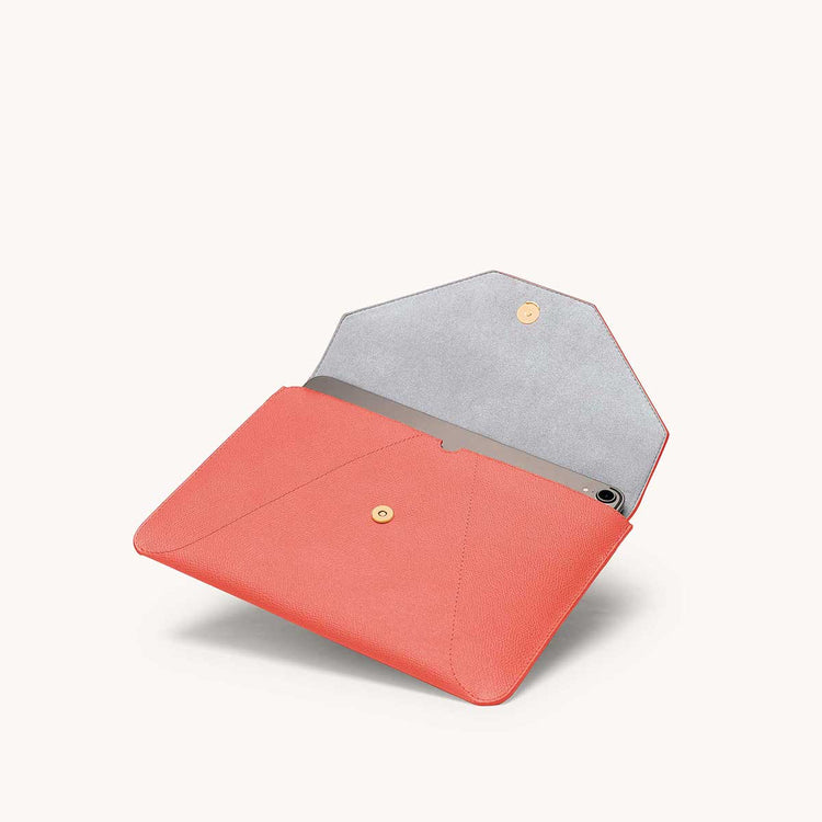 Mini envelope sleeve in coral angled view with flap open.