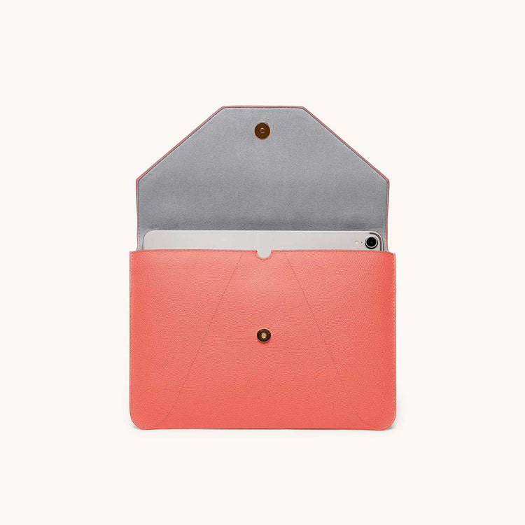 Mini envelope sleeve in coral front view with flap open.