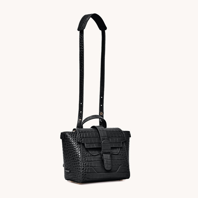 Mini Maestra Bag Dragon Noir with Gold Hardware Front at an Angle, Strap Extended at Top to Show Length