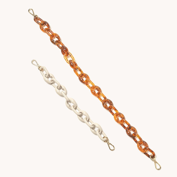 infinity acetate chain shoulder in tortoise next to acetate chain bracelet for size comparison