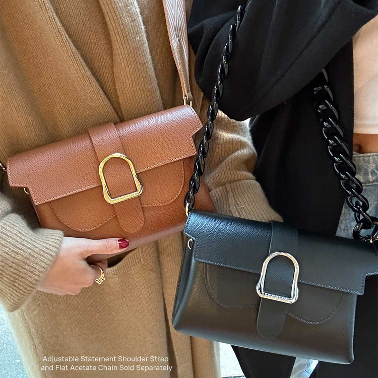 two women wearing a brown and black leather belt bags with added on chains and straps