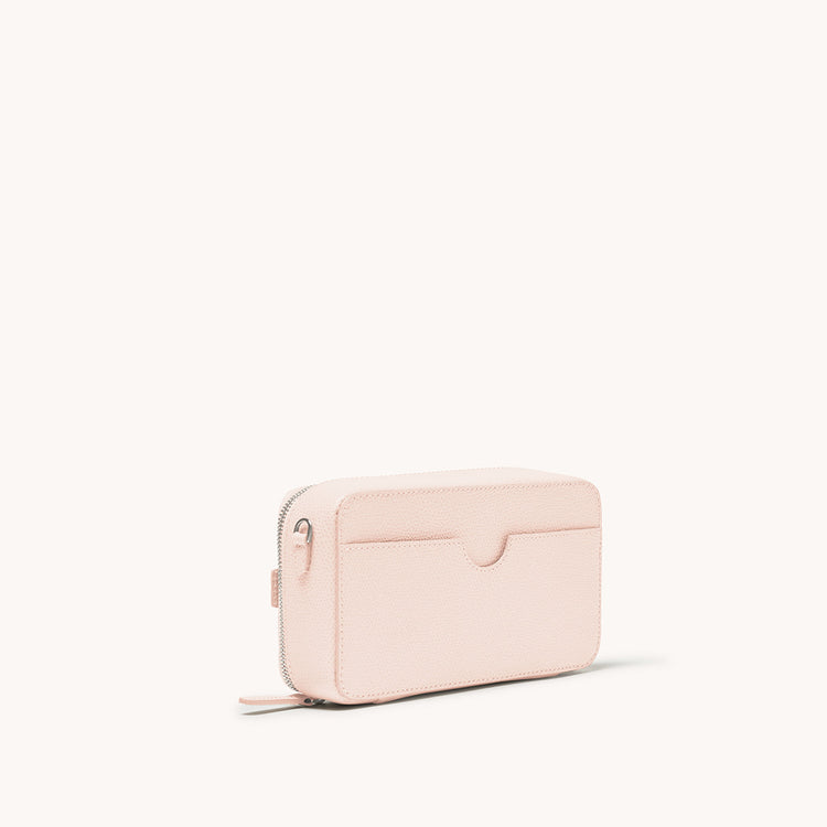 convertible jewelry box bag in pebbled blush side view showing back pocket