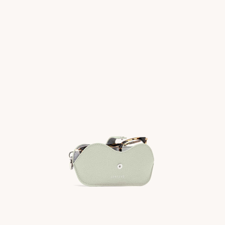 Lunettes case in mint with glasses inside front view.