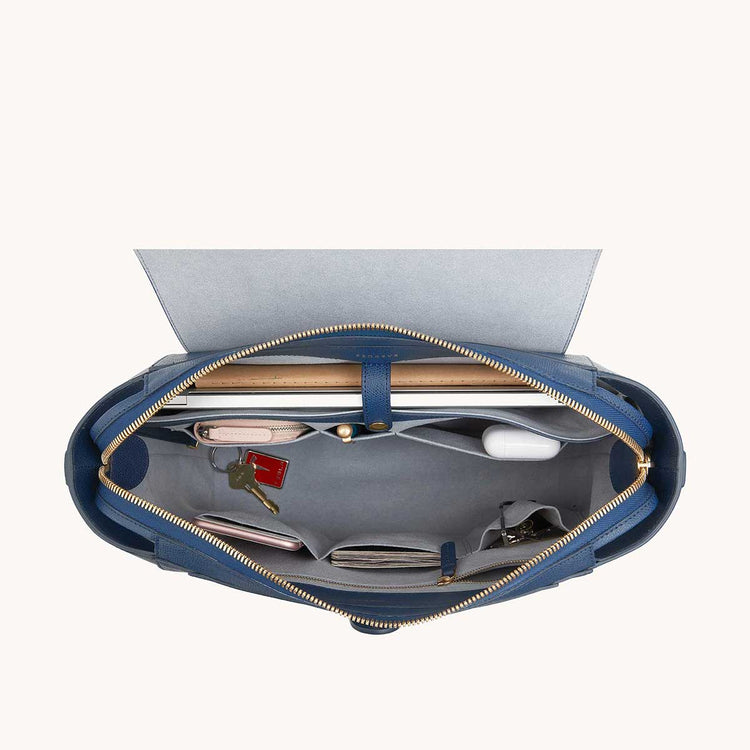 Maestra Bag Pebbled Marine with Gold Hardware Interior View with What Fits: laptop, keys, phone, cards, etc.