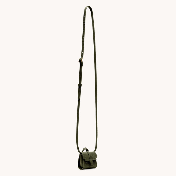 Milli maestra in forest view of shoulder strap.