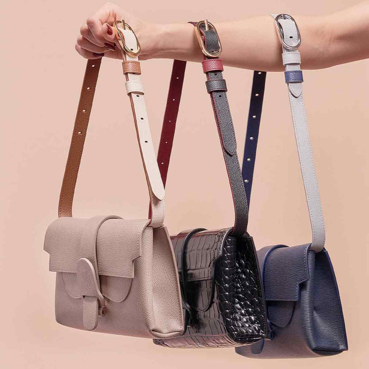 Aria Belt Bag in Sand, Noir, and Marine with Reversible Shoulder Strap Colorblock Chestnut, Noir, and Marine Attached Respectively
